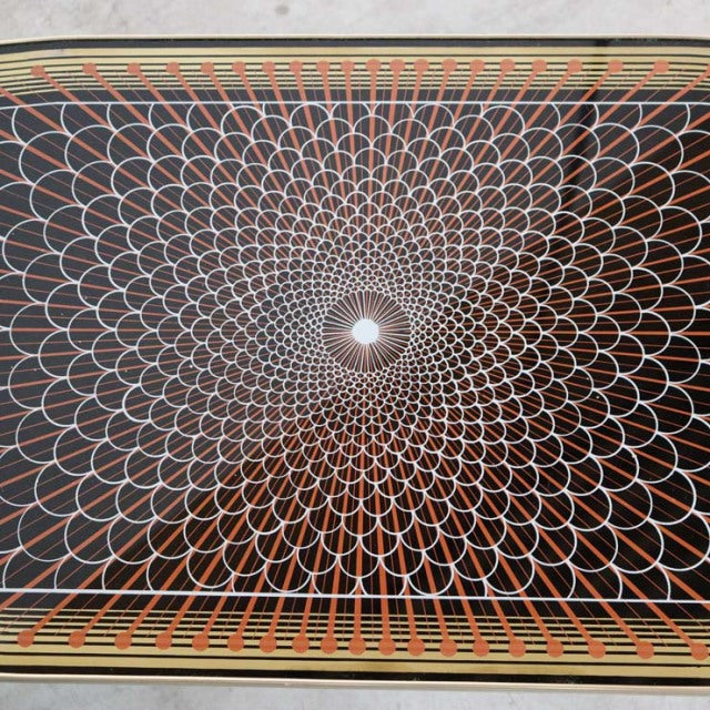 Mid-century vintage British teak coffee table with intricate radial geometric pattern and tapered legs.