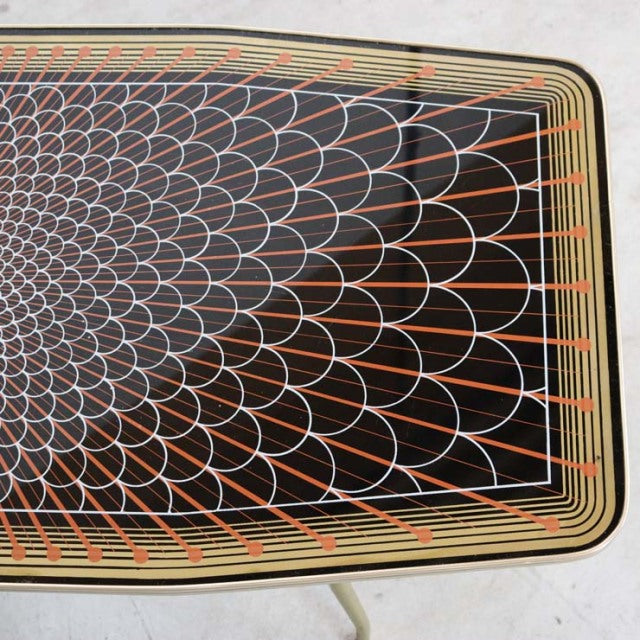 Mid-century teak coffee table with intricate geometric pattern on top, British vintage style from Denmark, smooth wood grain .