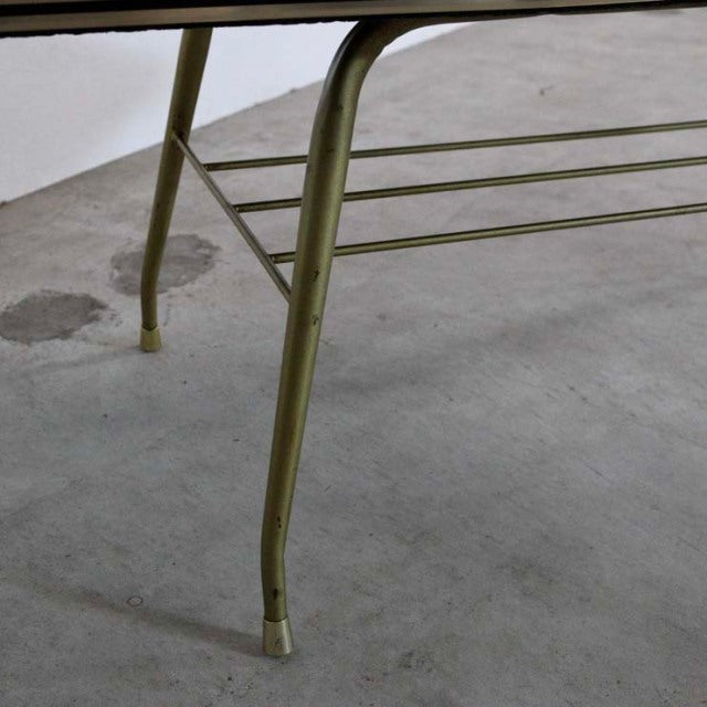 Mid-century teak coffee table leg with slim, curved British design and visible wood grain.