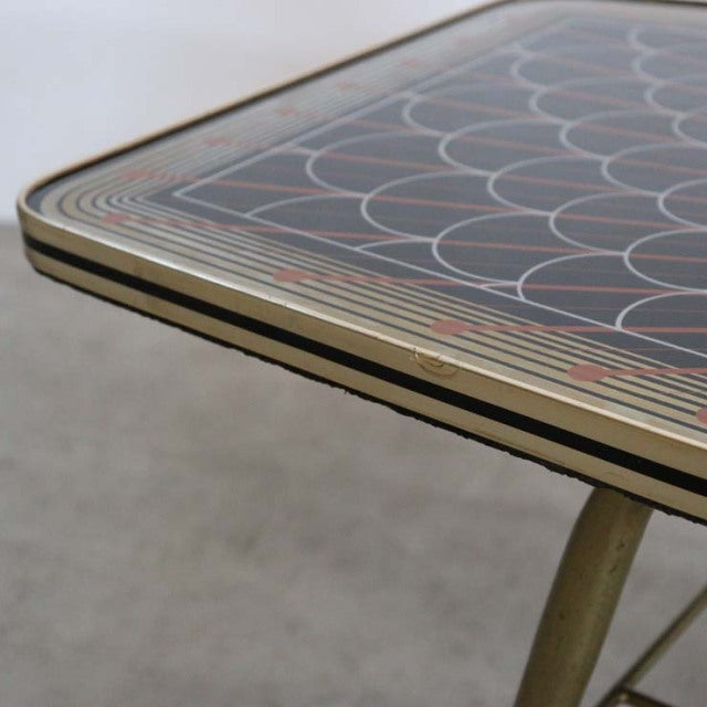 Vintage mid-century teak coffee table corner with intricate geometric patterned top and slender angled legs from.