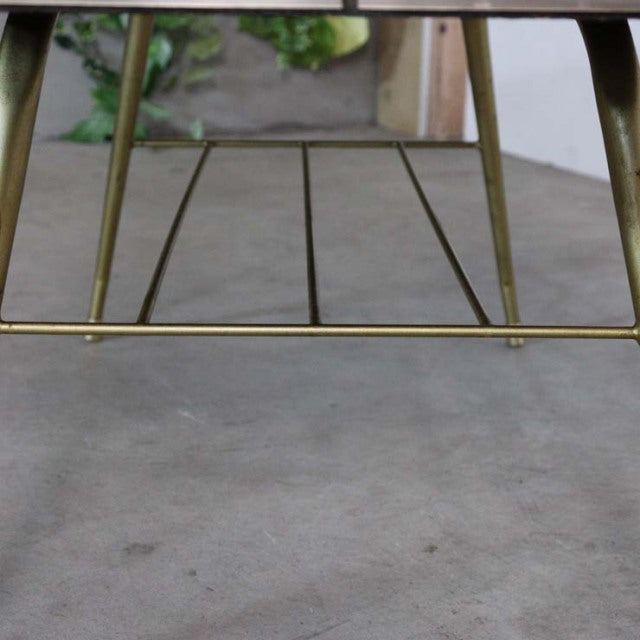 Mid-century British vintage teak coffee table with tapered legs and brass support bars, showcasing warm wood grain and.