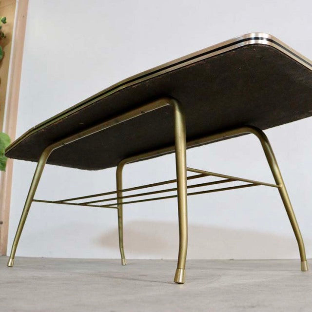 Mid-century British vintage teak coffee table with brass tapered legs and minimalist geometric support bars.