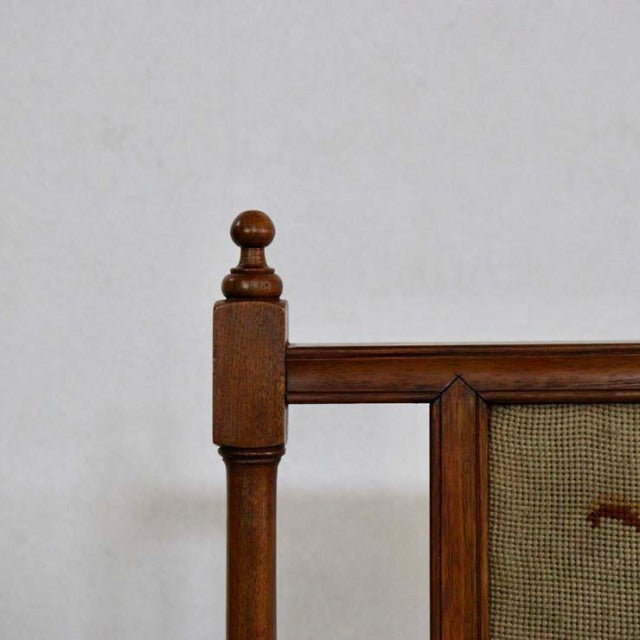 Mid-century British vintage teak fire screen with carved finial and woven mesh panel, rich wood grain.