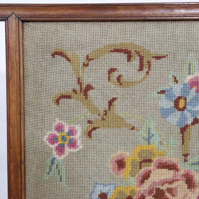 Vintage mid-century teak fire screen with detailed floral tapestry and solid wood frame.