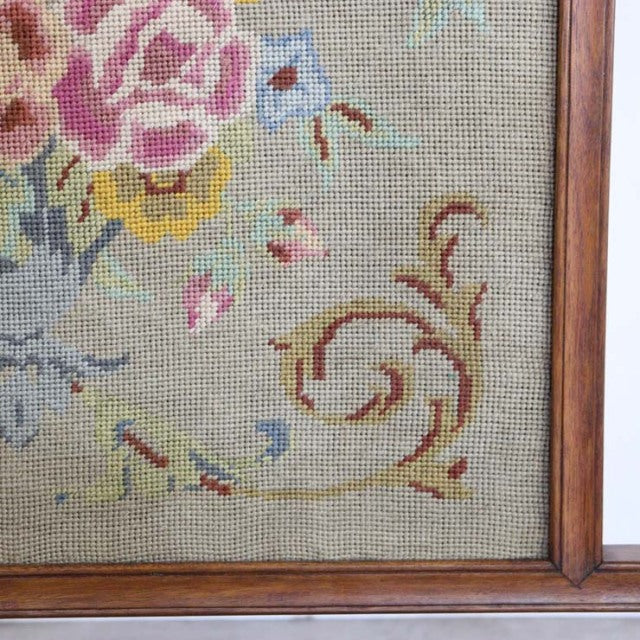 Mid-century British vintage teak fire screen with floral tapestry featuring detailed needlepoint and smooth wood grain frame.