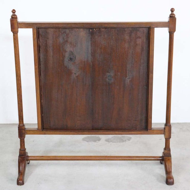 Vintage mid-century British teak fire screen with rich wood grain, turned posts, and sturdy crossbar base.