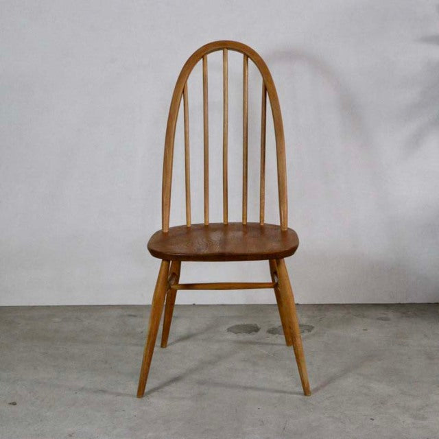 Mid-century British vintage Ercol Quaker chair in teak with spindle backrest and tapered legs.