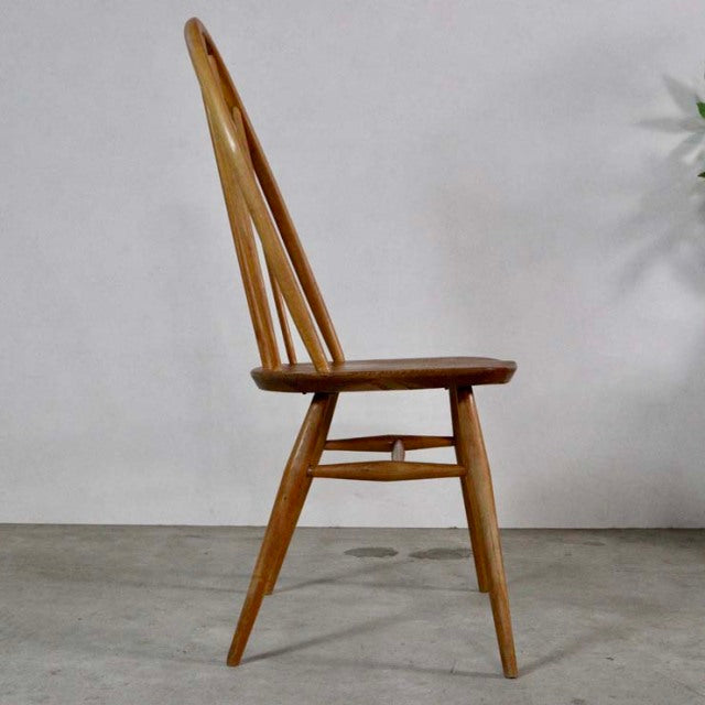 Vintage British mid-century Ercol Quaker dining chair in teak with spindle back and tapered legs.