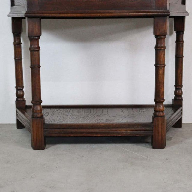 British vintage mid-century oak bedside cabinet with turned legs and lower shelf, rich wood grain visible.