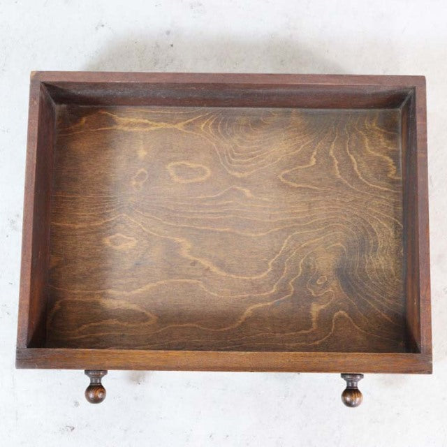 Vintage teak wood bedside cabinet drawer with visible wood grain and turned wooden knobs, British mid-century design from.