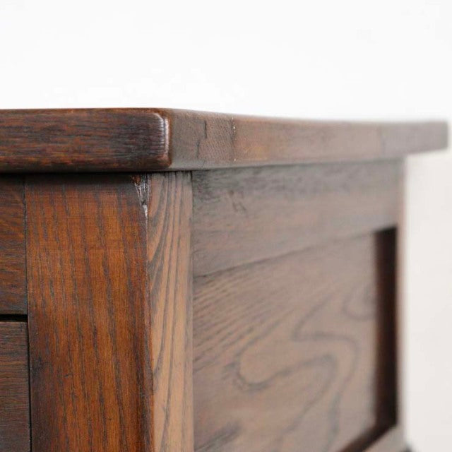 Vintage British mid-century teak bedside cabinet with visible wood grain and smooth rounded edges.