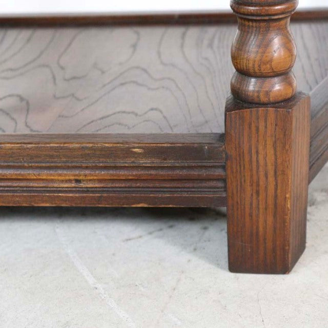 Close-up of vintage teak oak bedside cabinet leg showcasing rich wood grain and carved mid-century British craftsmanship.