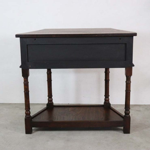 Vintage British mid-century teak bedside cabinet with turned legs and lower shelf, rich wood grain.