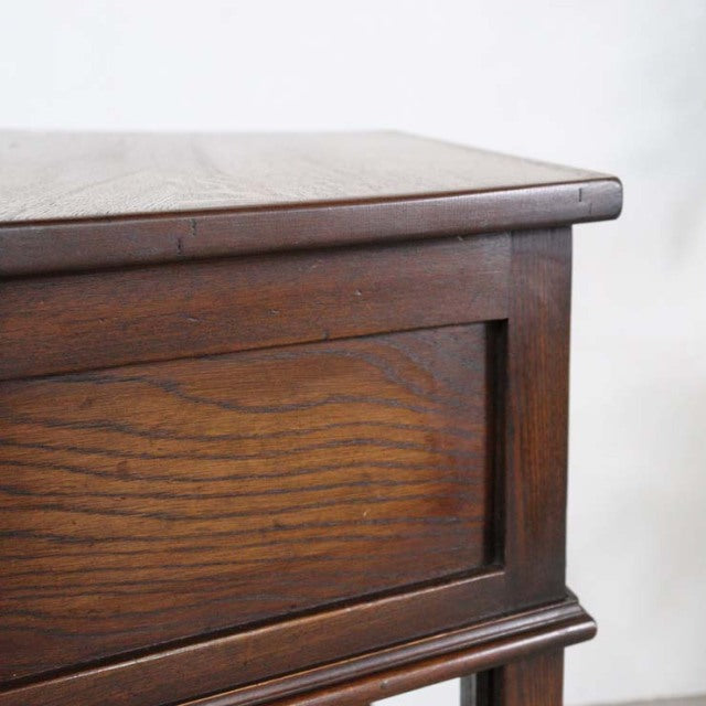 Vintage British mid-century teak bedside cabinet with rich wood grain and sturdy frame detailing.
