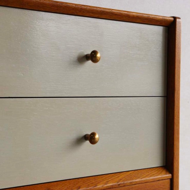Vintage mid-century teak chest by British G-Plan with smooth Chinese white drawer fronts and round brass knobs.