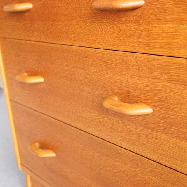Vintage British mid-century teak chest by G-PLAN with smooth wood grain and curved handles.