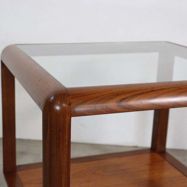 Mid-century British vintage teak coffee table with rounded wood grain edges and clear glass top.