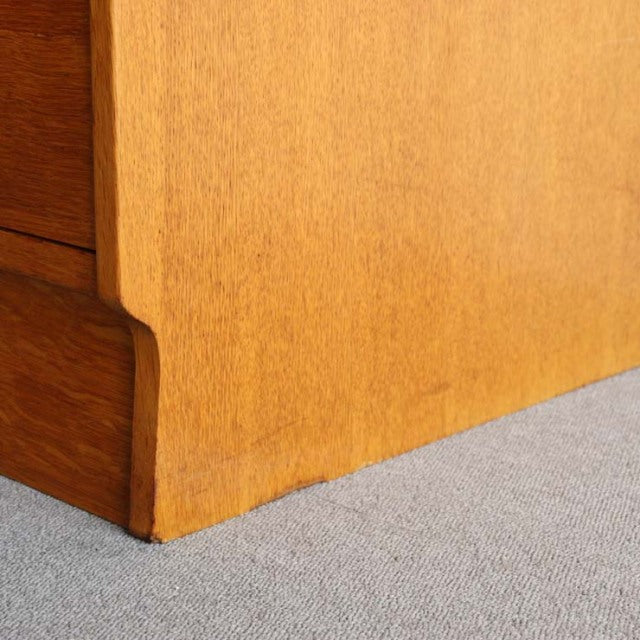 Close-up of vintage teak G-Plan chest corner showing mid-century British design with smooth wood grain and clean lines.