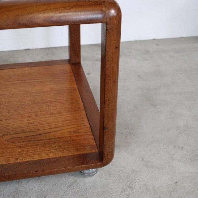 Vintage British mid-century teak coffee table with rounded cube frame and visible wood grain.