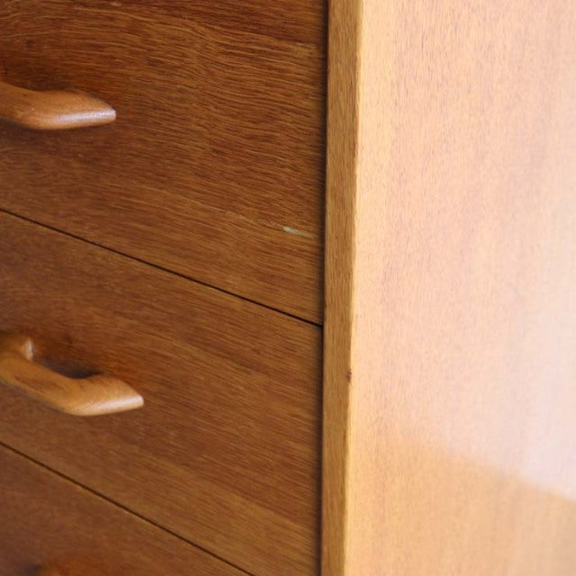 Mid-century British G-PLAN teak chest with smooth wood grain and curved handles in vintage Danish style.