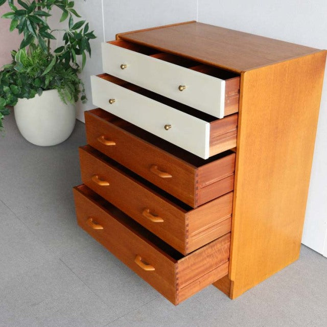 Vintage G-Plan teak chest with mid-century British design, featuring warm wood grain, four spacious drawers with teak.