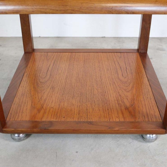 Vintage British mid-century teak cube coffee table with visible wood grain and metal ball feet.