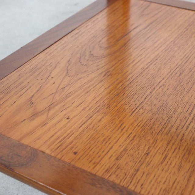 Vintage British mid-century teak coffee table with rich wood grain and smooth edges.