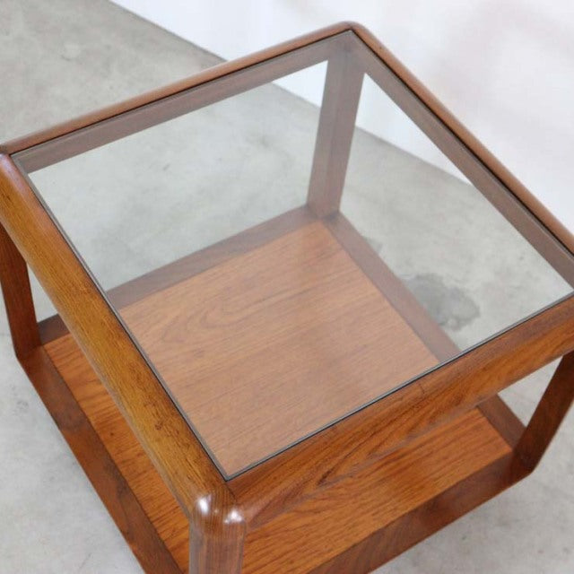 Vintage British mid-century teak cube coffee table with glass top and open frame design.
