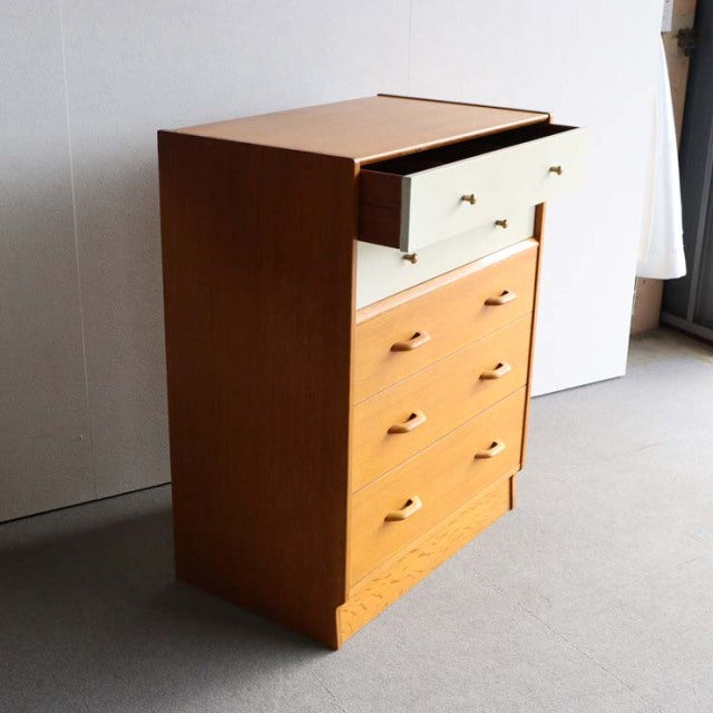 Mid-century British G-Plan teak chest with Chinese white top drawer, brass handles, and clean lines.