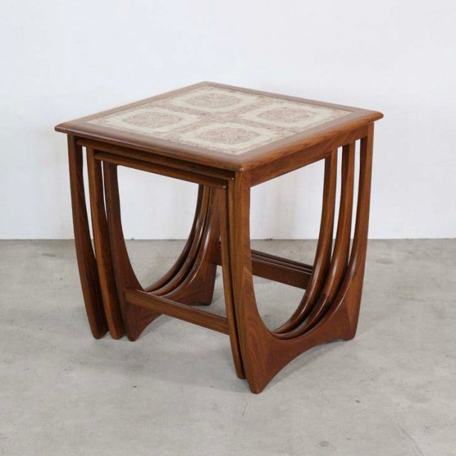 Vintage teak G-Plan nest table with British mid-century design, tile top inlaid, curved legs, Danish influence.
