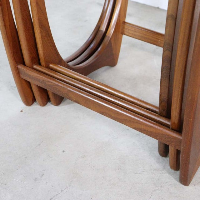 Vintage G-Plan teak nesting tables with smooth wood grain and rounded mid-century British design legs.
