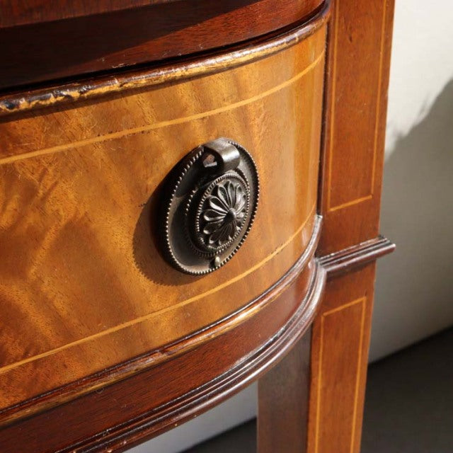Close-up of vintage British mid-century teak desk drawer with intricate carved wooden handle and rich wood grain detailing.
