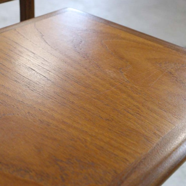 Vintage teak G-Plan mid-century nest table with smooth rounded edges and visible wood grain.