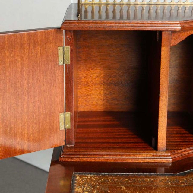 Vintage British mid-century teak desk with open brass-hinged cupboard, rich wood grain, clean lines, and classic.