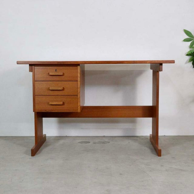 Vintage mid-century teak desk from Denmark with clean lines, three drawers on left, and sturdy straight legs.
