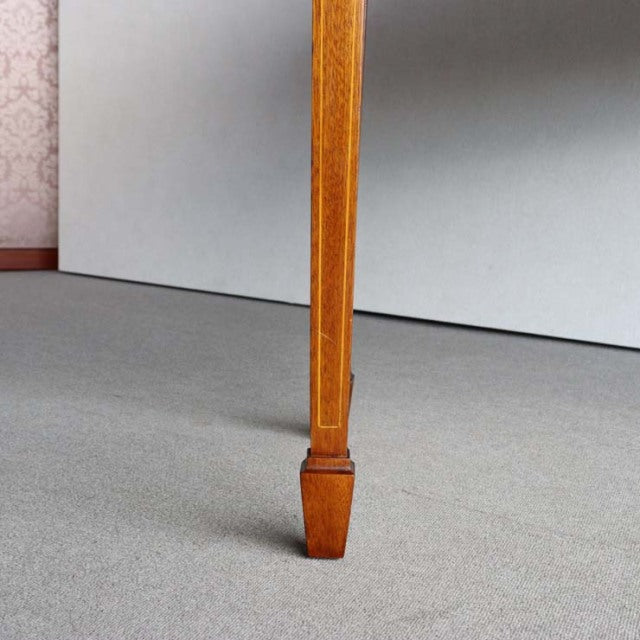 Vintage teak wooden desk leg with tapered square profile and subtle wood grain, mid-century British-Danish style.