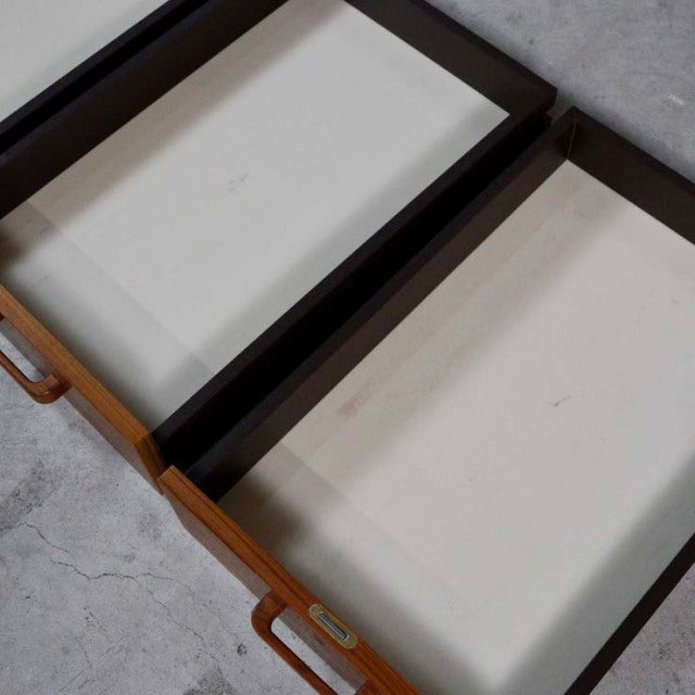Open teak drawers with visible wood grain and brass handles on mid-century Danish vintage desk.
