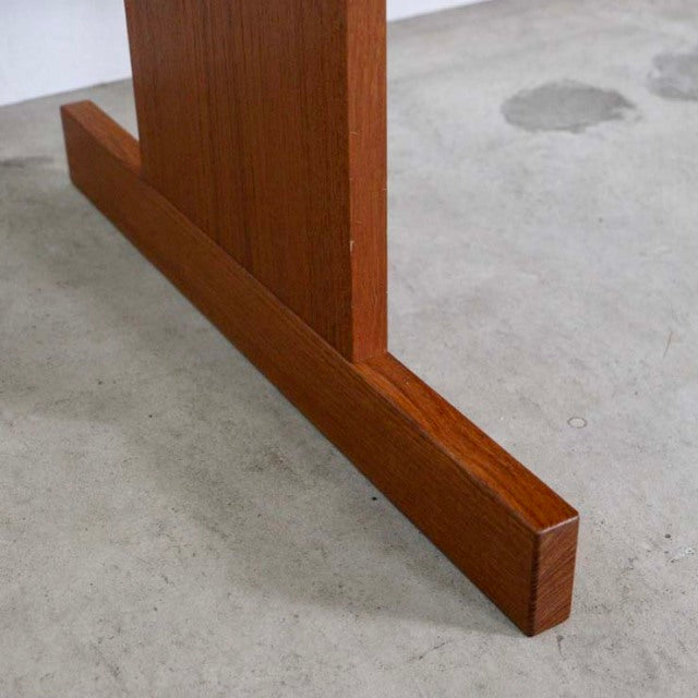 Mid-century teak wood desk leg with visible grain, showcasing Danish vintage craftsmanship and British design influences on.