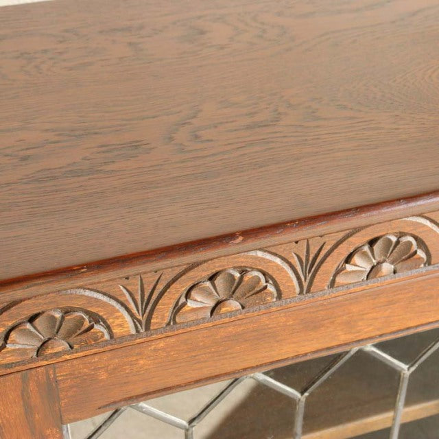 Close-up of teak wood cabinet top with carved floral detailing typical of British mid-century vintage design.