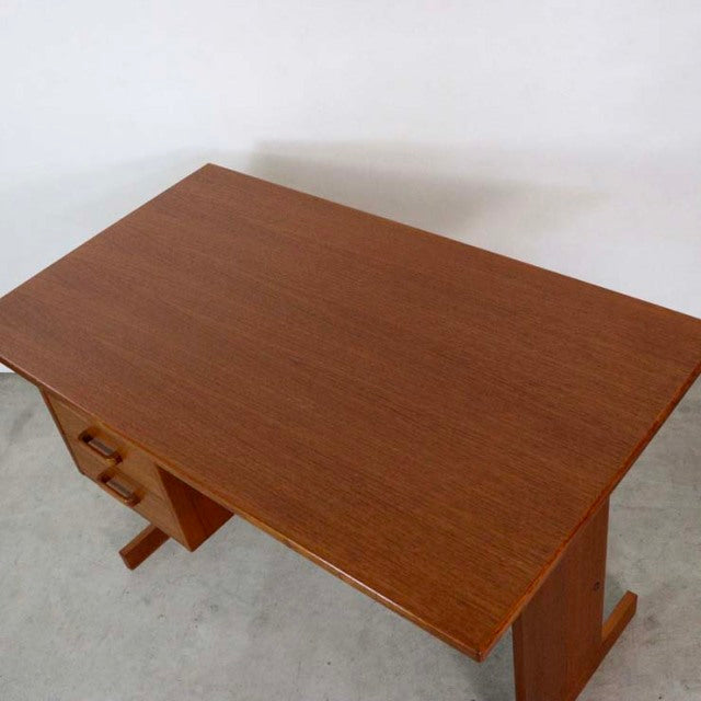 Mid-century vintage teak desk from Denmark with smooth wood grain and sturdy rectangular top.