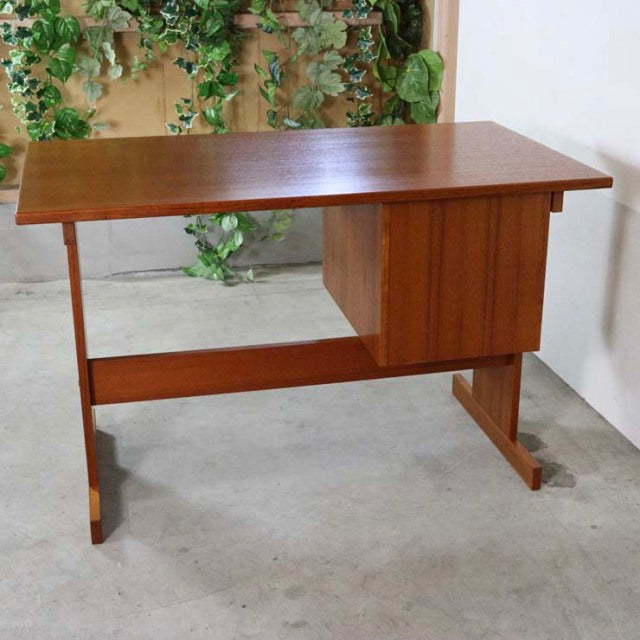 Mid-century vintage teak desk from Denmark with clean lines, sturdy legs, and a compact side cabinet.