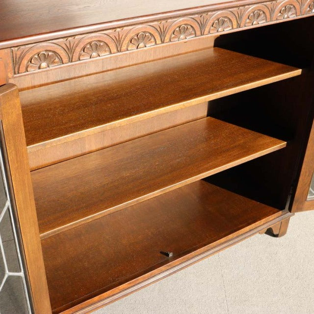 Mid-century British teak cabinet by Jaycee, with smooth wood grain and adjustable shelves, showcasing vintage craftsmanship.