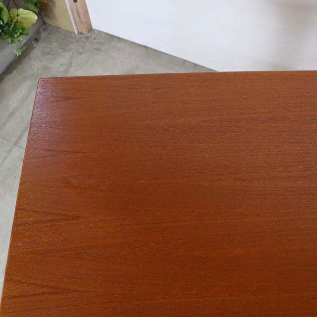 Mid-century vintage teak desk top with smooth grain and sharp edges, Danish design visible from wood texture.