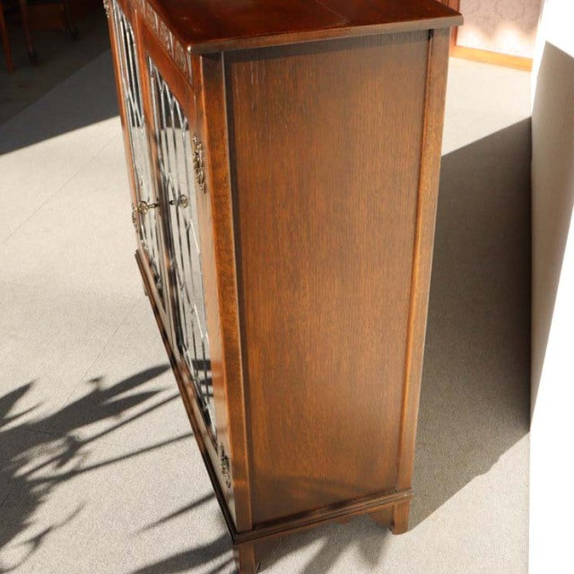 Vintage teak cabinet by British Jaycee, mid-century Denmark style, smooth wood grain, tapered legs, warm brown finish.
