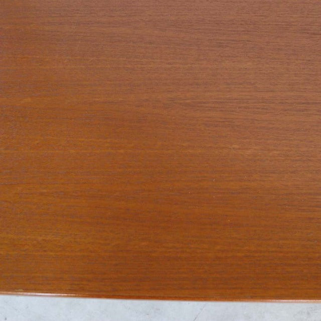 Mid-century vintage teak desk surface showing rich wood grain and warm brown finish from British-Denmark design.