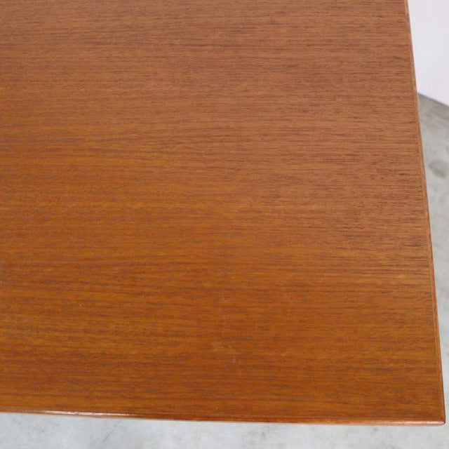Close-up of vintage mid-century teak desk surface showcasing fine wood grain from Danish British-inspired design.