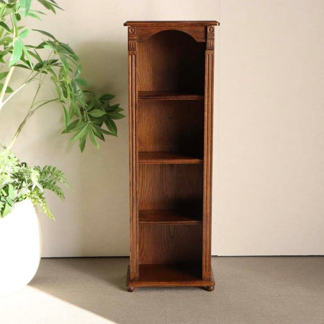 Tall vintage teak cabinet with British mid-century design, featuring open shelving and carved corner details.