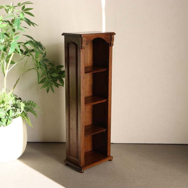Tall vintage teak cabinet with British mid-century design, four open shelves, elegant wood grain, slim vertical frame,.