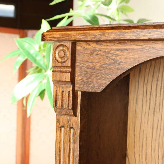 Close-up of vintage British oak cabinet corner with carved detailing and rich wood grain, mid-century style from Denmark.
