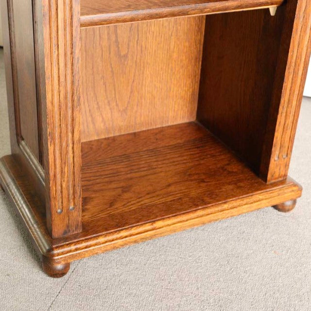 Vintage British mid-century teak cabinet base with rich wood grain, rounded feet, and fluted corner details.